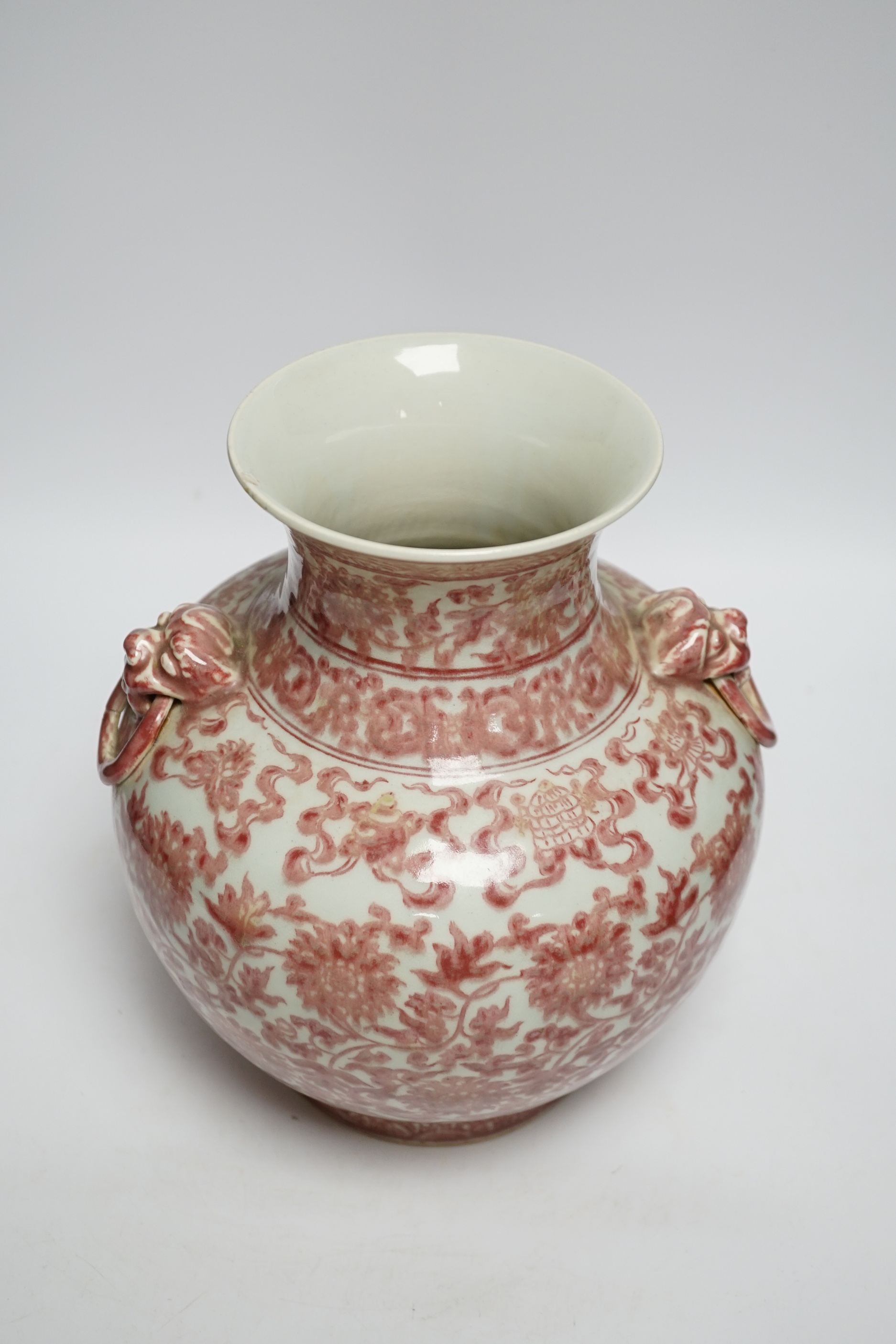 A Chinese underglaze copper red floral vase with twin handles, 27cm high
